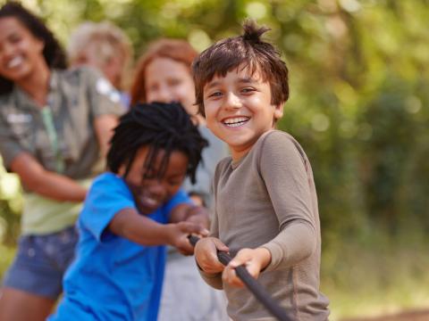 Youth playing tug-of-war outside.