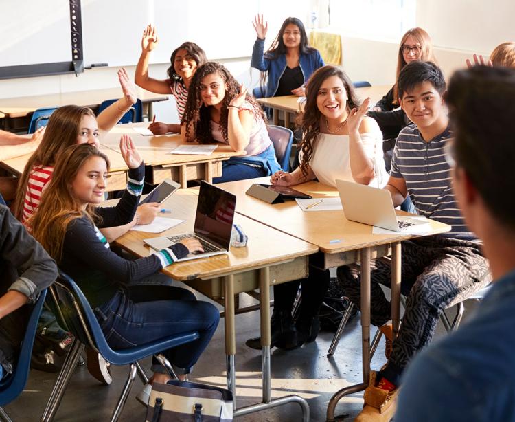 Group of students sitting at a desk.