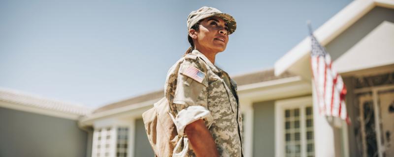 Female service member standing outside.